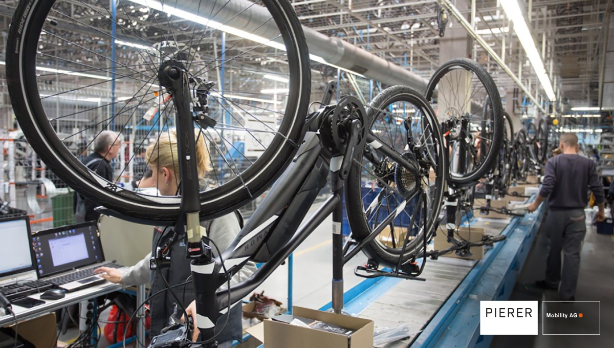 Degli operai assemblano bici elettriche in uno stabilimento Pierer Mobility AG in Europa